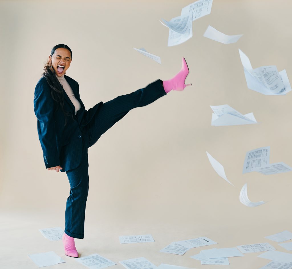 Person kicking paperwork representing simplified compliance